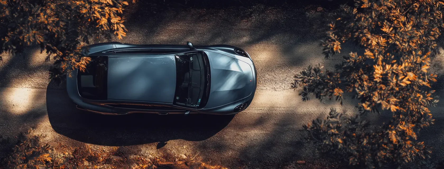 Overhead drone shot of a sleek modern car parked
