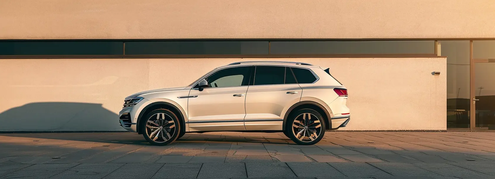 Volkswagen SUV parked outdoors in front of a wall